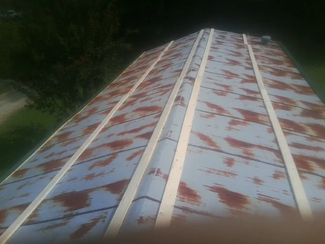 Rusted metal roof panels with new wood purlins before replacement — Storm Damage Roof Repair in Palos Hills by Roofing Brothers